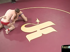 Wrestling hunk stroking opponents cock