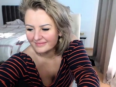 Curvy blonde cougar showing off big natural tits on webcam