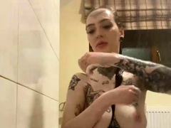 Webcam model exposing her sexy tattooed body in the shower